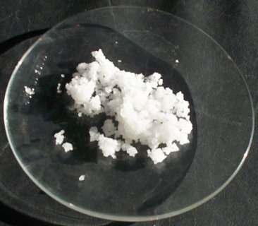 White lumped powder on a glass